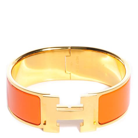 orange hermes clic clac bracelet.